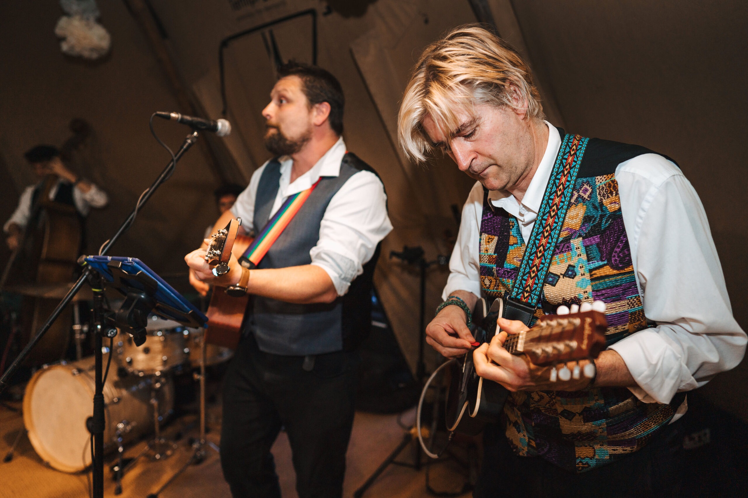 The Southern Sons - Guitar and Singer The picture shows a guitarist and singer performing at an event dressed in white shirts and waist coats