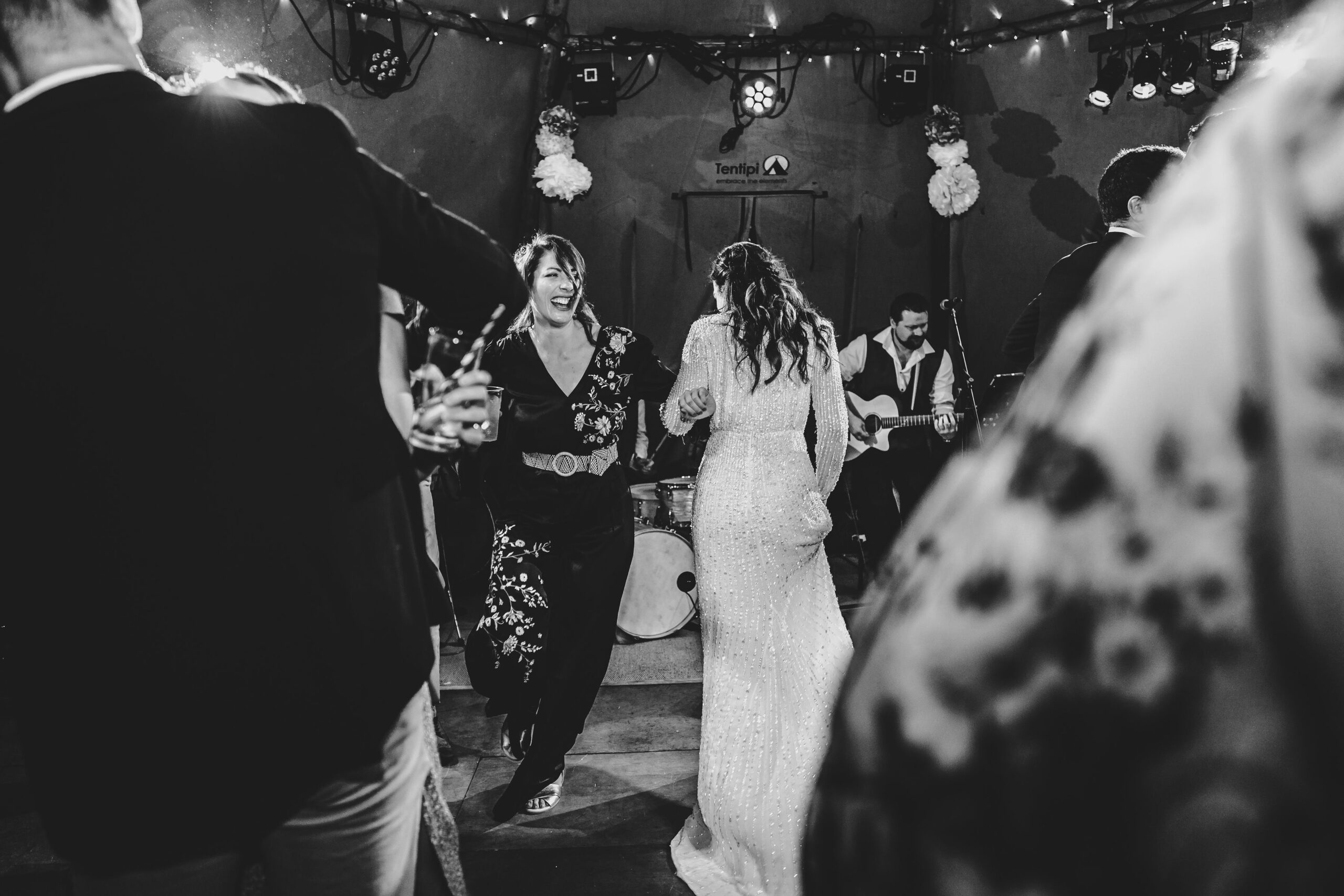 Singer and Wedding Crowd Black and white photo og bride in white dress dancing whilst The Southern Sons vocalist performs for a crowd